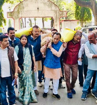 कंधे पर धान लादकर कलेक्टोरेट पहुंचे कांग्रेस नेता